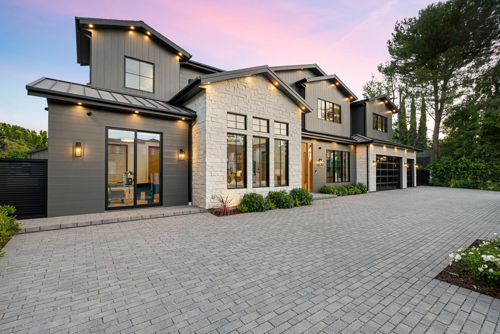 Modern gray and stone home at sunset