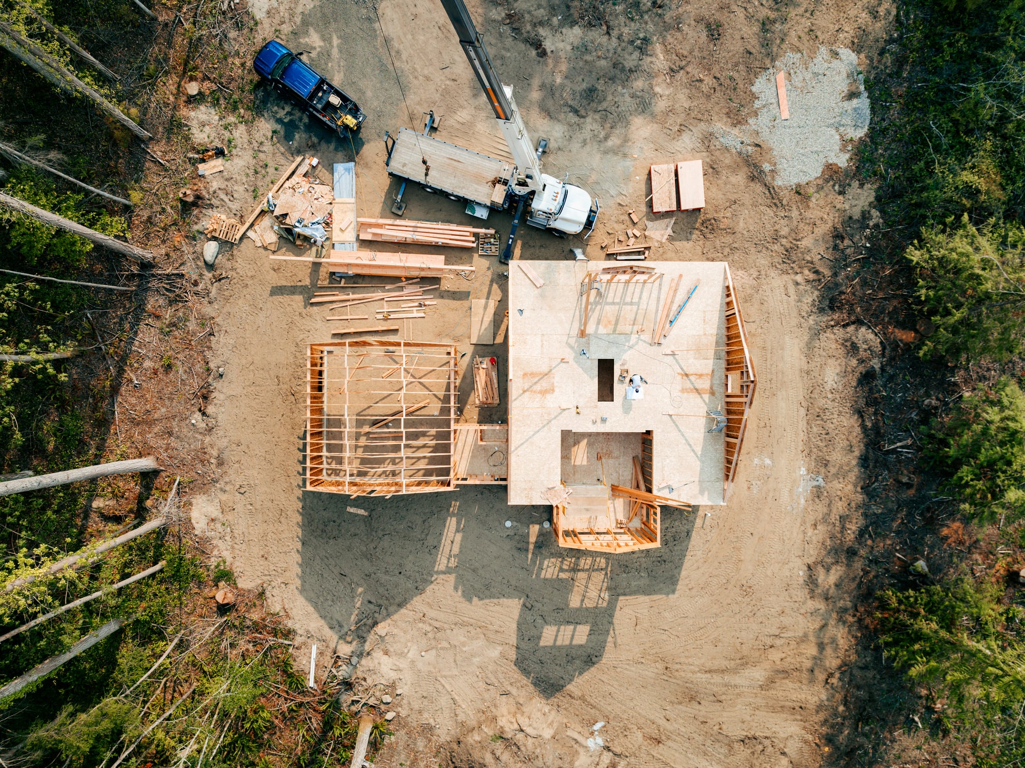 Aerial view of house construction site in forest clearing