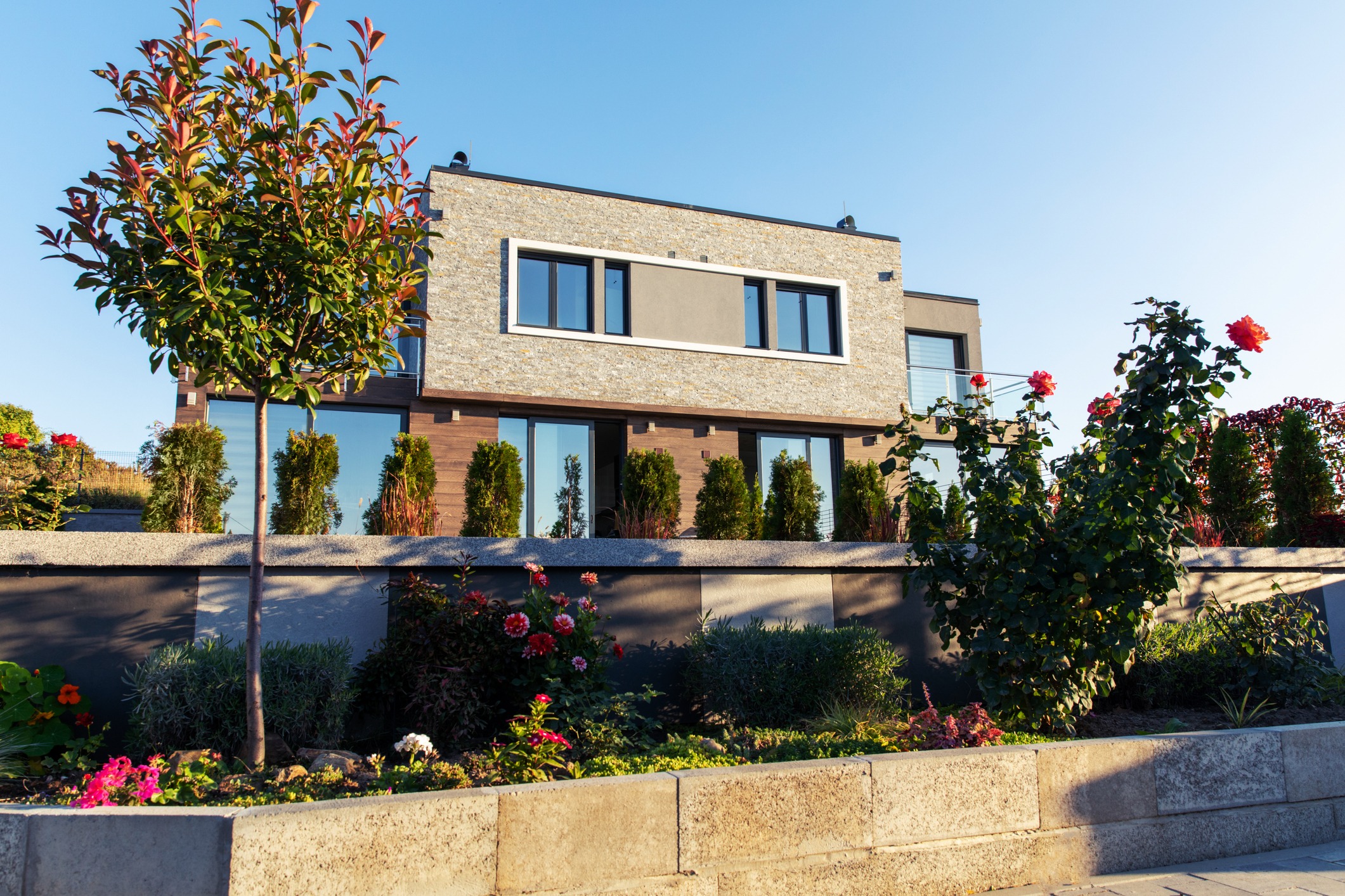 Modern two-story home with landscaped flower garden