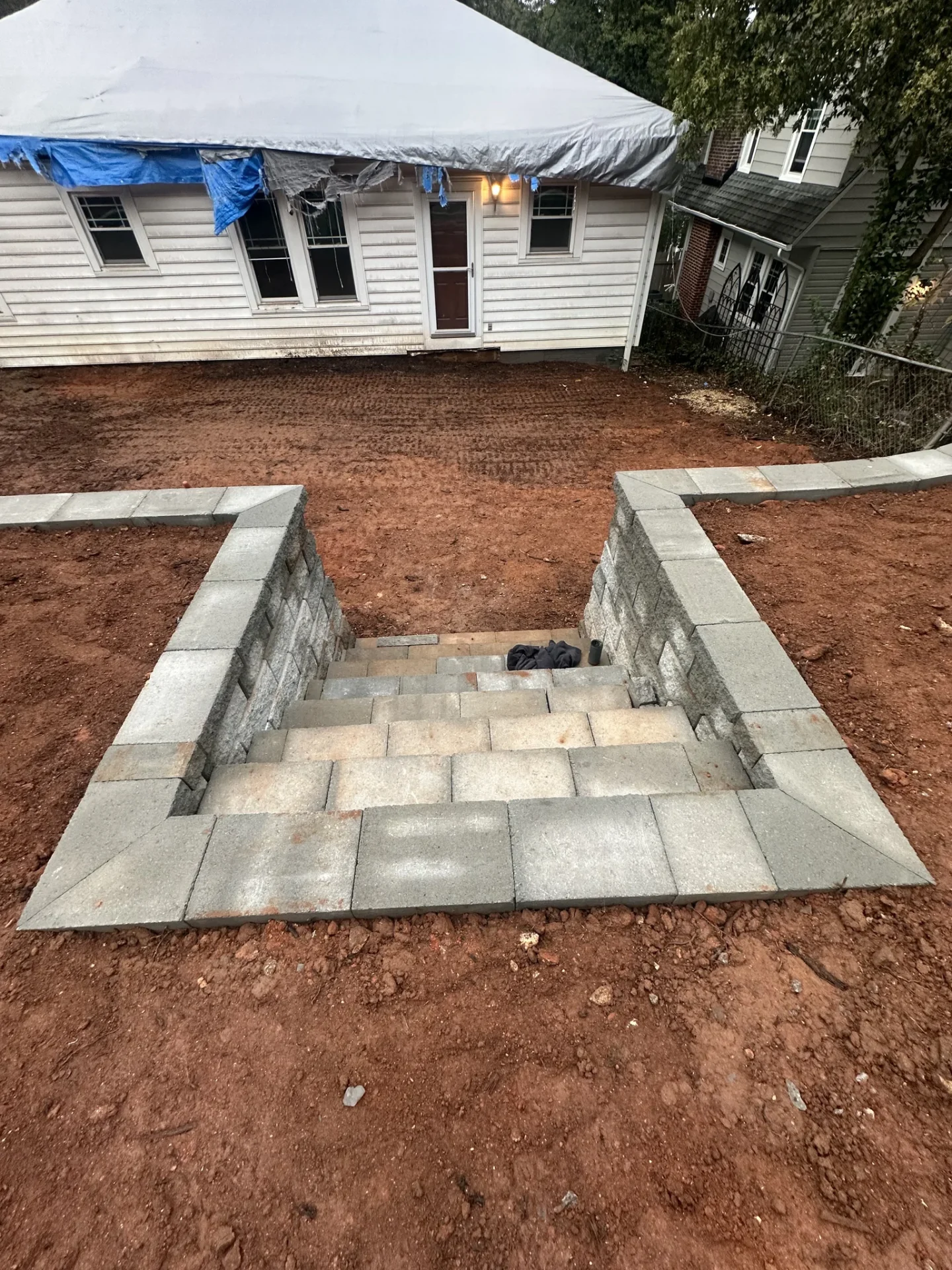 New stone staircase and retaining walls beside house