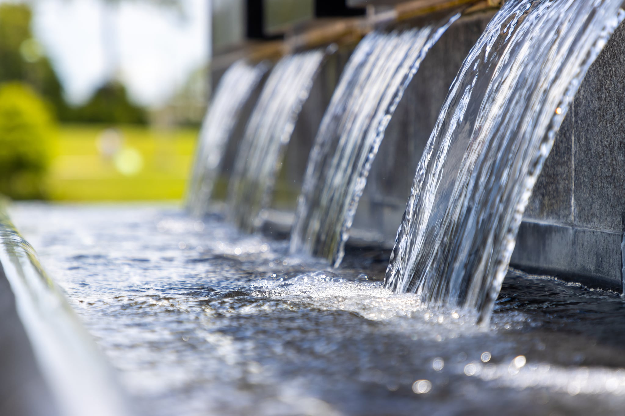Water cascading from a stone fountain into a pool