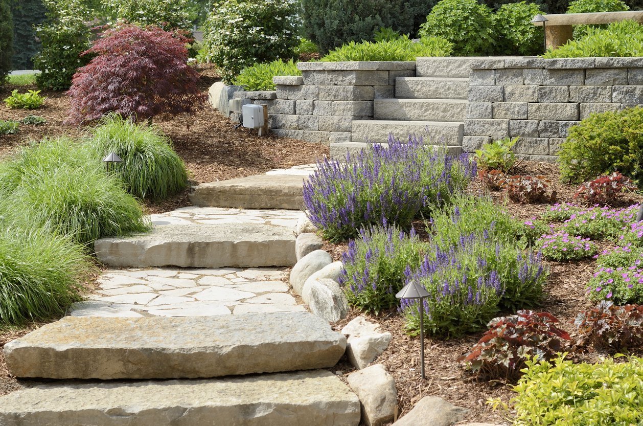 Stone garden steps beside flowering landscaped beds